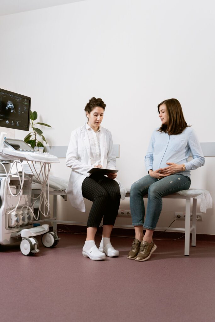 A nurse talking with an expectant mother during a pregnancy consultation